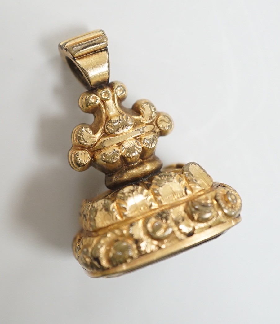 A Victorian yellow metal overlaid mounted citrine fob seal, the matrix carved with fox hunting scene, 34mm.